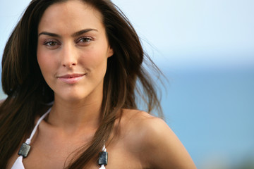 Close-up of brunette at the seaside