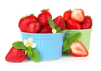Ripe sweet strawberries in bowls, isolated on white
