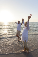 Happy Senior Couple Walking Holding Hands Tropical Beach