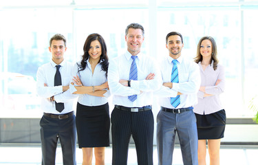 Portrait of businessman leading his team at office