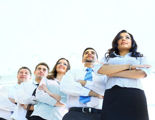 Happy young business woman with her team in background