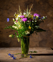 Beautiful bouquet of bright wildflowers in vase