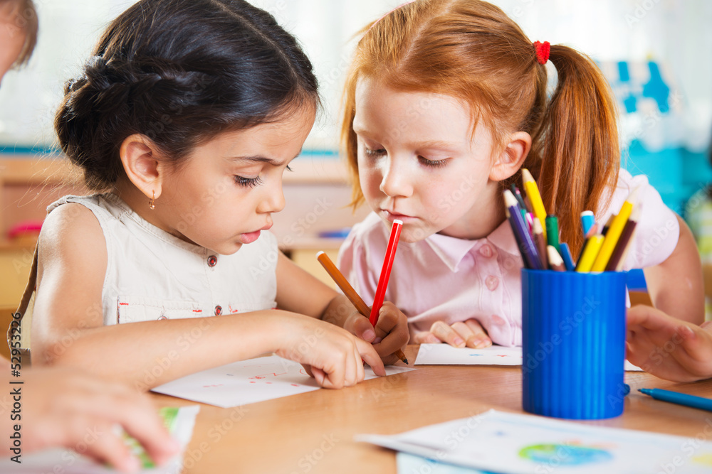 Wall mural cute preschoolers drawing with colorful pencils