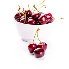 Sweet fresh cherry in a bowl isolated