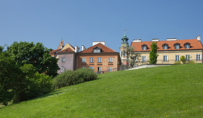 colorful houses of warsaw old town over green hill