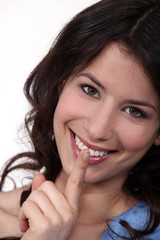 Fototapeta premium Smiling woman asking for silence
