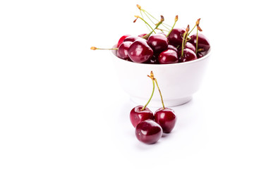 Sweet fresh cherry in a bowl isolated