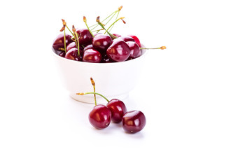 Sweet fresh cherry in a bowl isolated