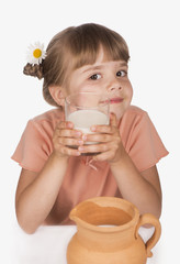 Little girl drinking milk isolated on white background