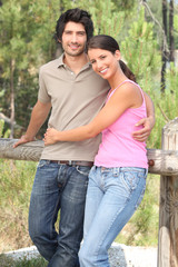 Happy couple stood in forrest