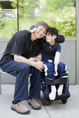 Disabled boy hugging father while waiting at hospital