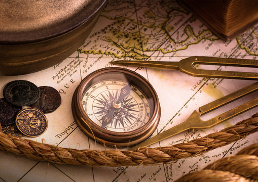 Vintage compass lies on an medieval map