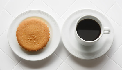 black and hot coffee in white cup with butter cake or bread for breakfast food and morning drink on top view