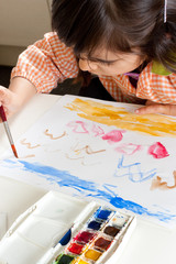 Little girl painting birds