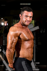 Fototapeta na wymiar muscular bodybuilder showing his side triceps