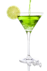 Pouring a green cocktail into a martini glass