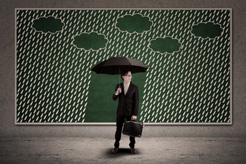 Businessman and umbrella with copyspace