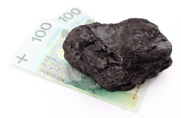 Large coal lump with money on white background
