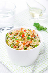 bowl of salad with bulgur, zucchini, tomatoes, chili peppers