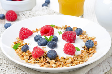 closeup of homemade muesli with yogurt, raspberries, blueberries