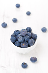 Fresh blueberries in a bowl, vertical, top view
