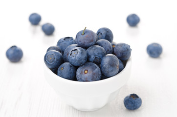 Fresh blueberries in a white bowl, horizontal