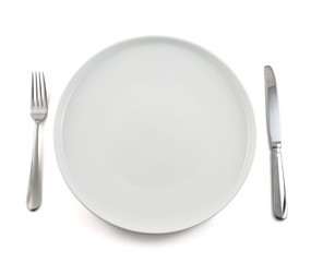Table knife, fork and ceramic plate isolated