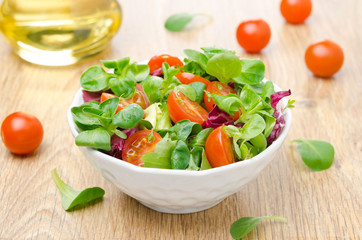 fresh salad and cherry tomatoes in a bowl horizontal