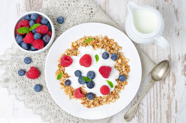 homemade muesli with yogurt, raspberries, blueberries top view