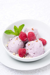 ice cream with fresh raspberries in a bowl vertical