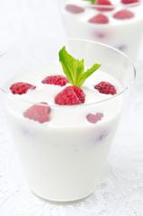 panna cotta with fresh raspberries in glasses closeup