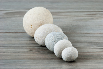 Five river stones on a table