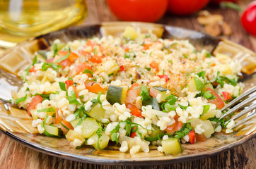 salad with bulgur, zucchini, tomatoes, chili peppers