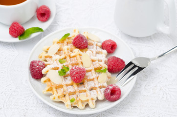 waffles, fresh raspberries and tea for breakfast