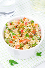 bowl of salad with bulgur, zucchini, tomatoes and parsley