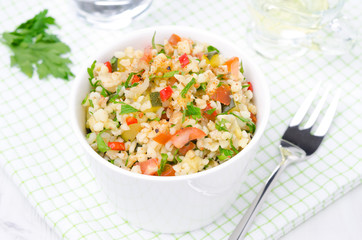 white bowl of salad with bulgur, zucchini, tomatoes and parsley