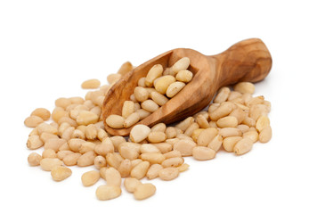 pine nuts in a wooden scoop