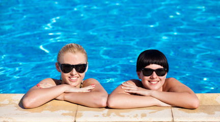 beautiful females model posing by the pool