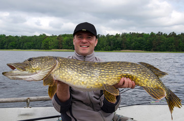 Happy angler with monster pike