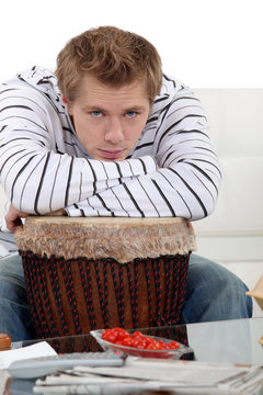 Man with his arms on his drum