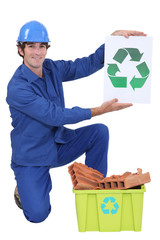 Builder holding recycle sign