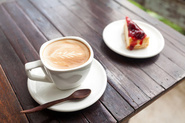 Cup of latte coffee with strawberry cheesecake