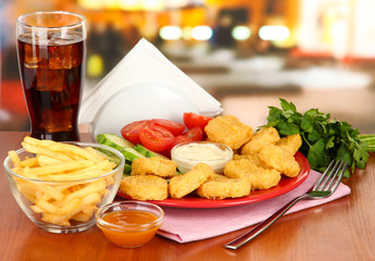 Fried chicken nuggets with vegetables,cola,french fries and