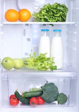 Open refrigerator with vegetarian food