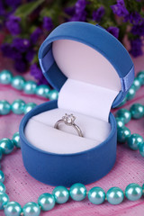 engagement ring on pink cloth