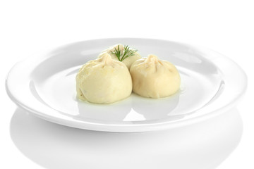 Tasty khinkali on plate, isolated on white