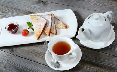 Toasts with powdered sugar and strawberry jam