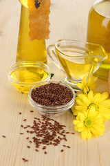 Useful linseed oil on wooden table close-up