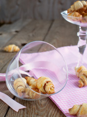Rugelach with cinnamon and sugar filling in bowl on the wooden t