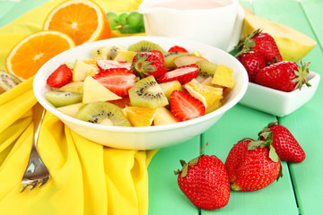 Useful fruit salad of fresh fruits and berries in bowl
